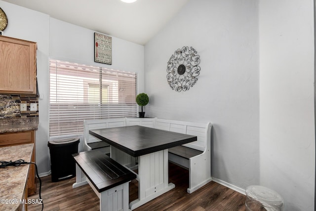 dining room with baseboards and dark wood-style flooring