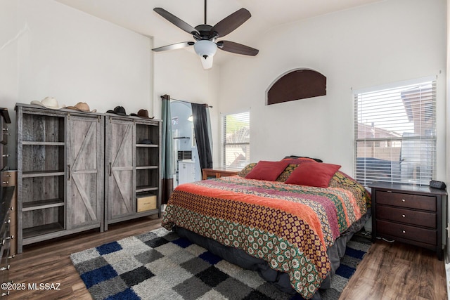bedroom featuring a ceiling fan, lofted ceiling, and wood finished floors