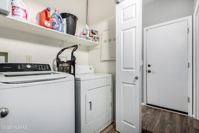 clothes washing area featuring separate washer and dryer, laundry area, and wood finished floors