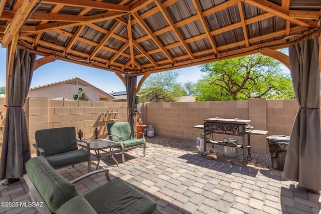 view of patio with a gazebo and fence