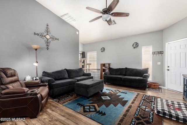 living area with high vaulted ceiling, ceiling fan, wood finished floors, and visible vents