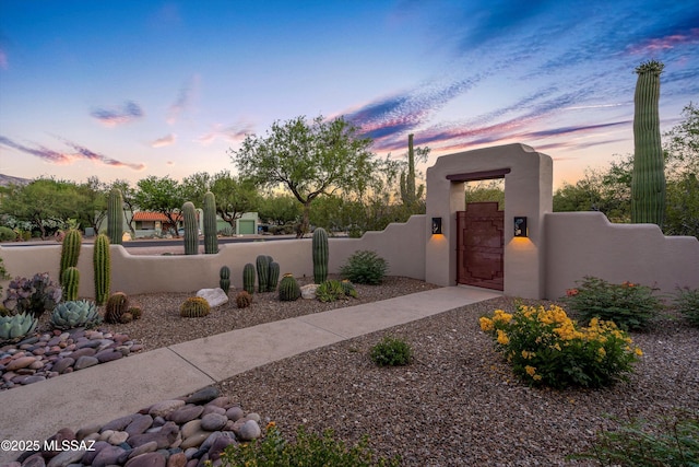 12431 E Cape Horn Dr, Tucson, AZ 85749 - view of front of property with a gate, a fenced front yard, and stucco siding