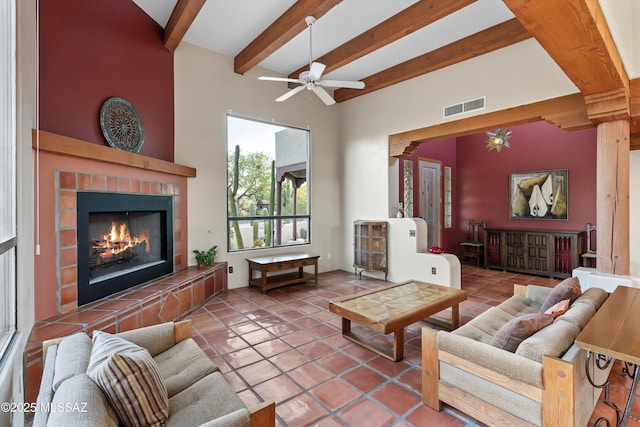 12431 E Cape Horn Dr, Tucson, AZ 85749 - living room featuring a tiled fireplace, beam ceiling, tile patterned floors, ceiling fan, and a high ceiling