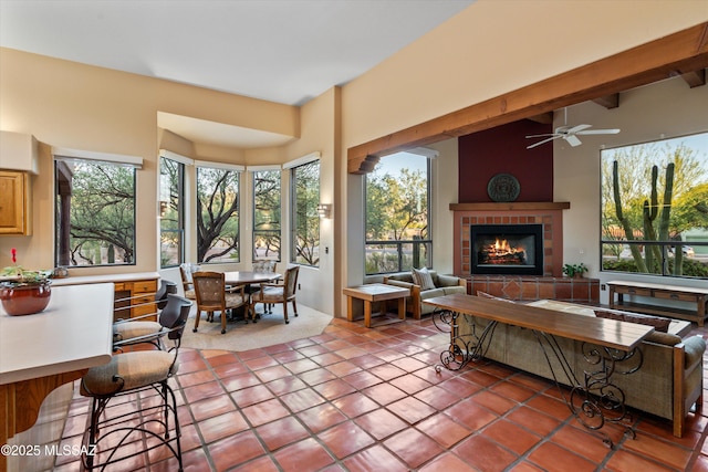 12431 E Cape Horn Dr, Tucson, AZ 85749 - tiled living room featuring plenty of natural light, a fireplace, and ceiling fan