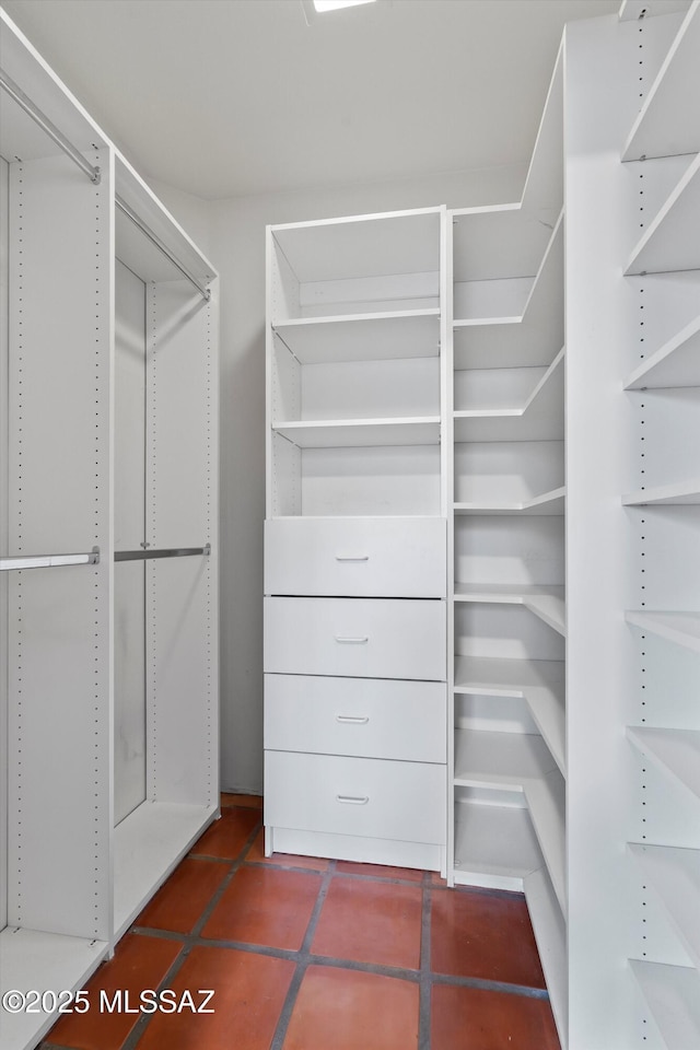 12431 E Cape Horn Dr, Tucson, AZ 85749 - walk in closet featuring dark tile patterned floors