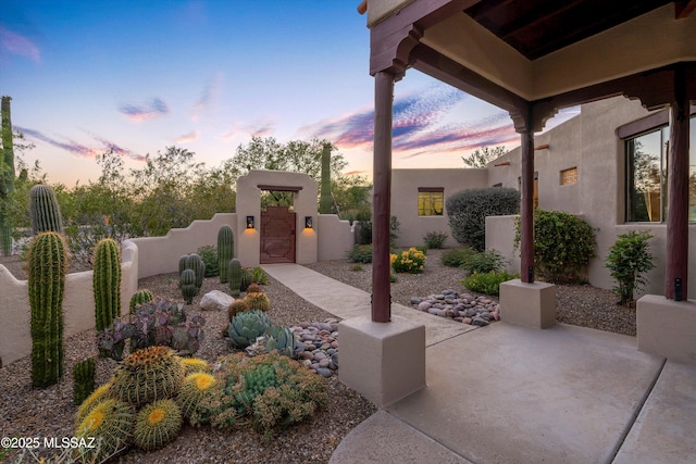12431 E Cape Horn Dr, Tucson, AZ 85749 - patio terrace at dusk with a gate and a patio area