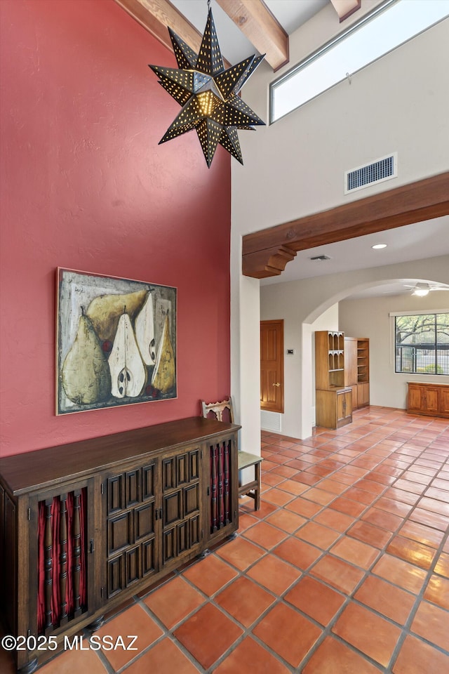 12431 E Cape Horn Dr, Tucson, AZ 85749 - tiled entryway featuring a towering ceiling, arched walkways, and beamed ceiling