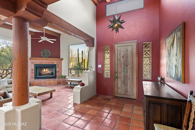 12431 E Cape Horn Dr, Tucson, AZ 85749 - tiled foyer with ceiling fan, a towering ceiling, and a fireplace