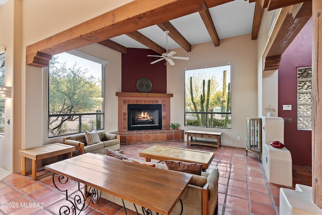 12431 E Cape Horn Dr, Tucson, AZ 85749 - living area with beamed ceiling, tile patterned flooring, ceiling fan, and a tile fireplace