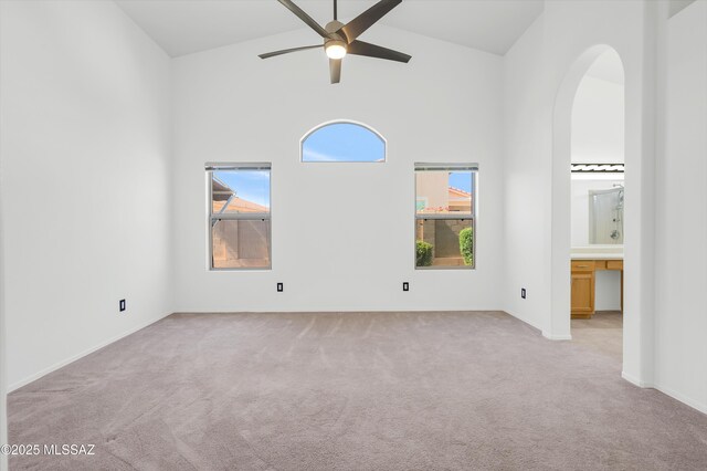 114 W Freddie Canyon Way, Oro Valley, AZ 85755 - empty room with ceiling fan, light colored carpet, arched walkways, high vaulted ceiling, and baseboards