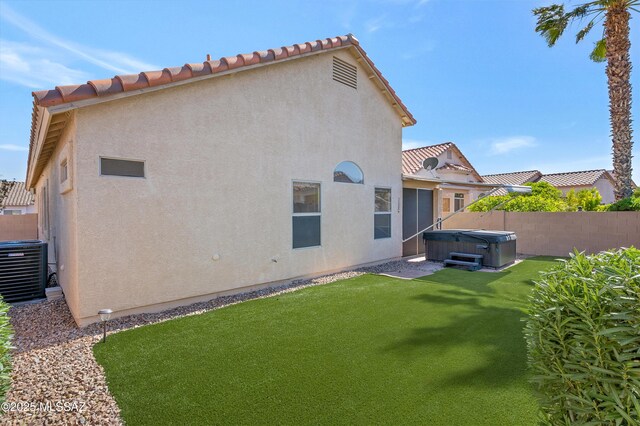 114 W Freddie Canyon Way, Oro Valley, AZ 85755 - rear view of house with a fenced backyard, stucco siding, central AC unit, a hot tub, and a yard