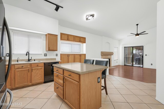 114 W Freddie Canyon Way, Oro Valley, AZ 85755 - kitchen with a fireplace, a sink, fridge with ice dispenser, light tile patterned floors, and black dishwasher