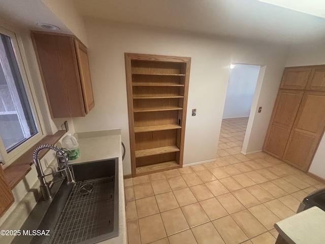 334 S Las Hamacas, Green Valley, AZ 85614 - kitchen featuring light countertops, light tile patterned floors, built in shelves, and a sink