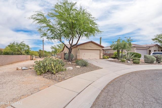 3486 W Sagebrush Hills Ct, Tucson, AZ 85741 - view of front of house featuring a garage, concrete driveway, stucco siding, and fence