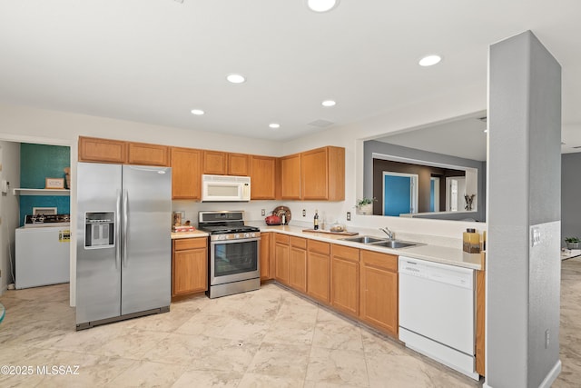 3486 W Sagebrush Hills Ct, Tucson, AZ 85741 - kitchen with stainless steel appliances, washer / dryer, a sink, light countertops, and recessed lighting