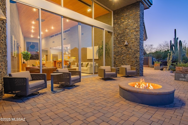 view of patio / terrace with an outdoor living space with a fire pit