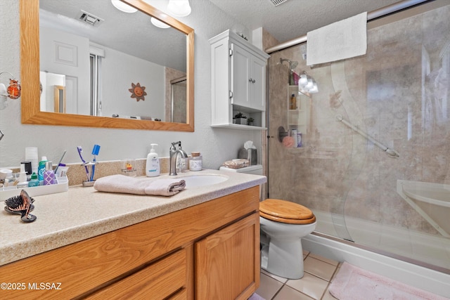 full bathroom featuring visible vents, tile patterned flooring, a stall shower, vanity, and toilet