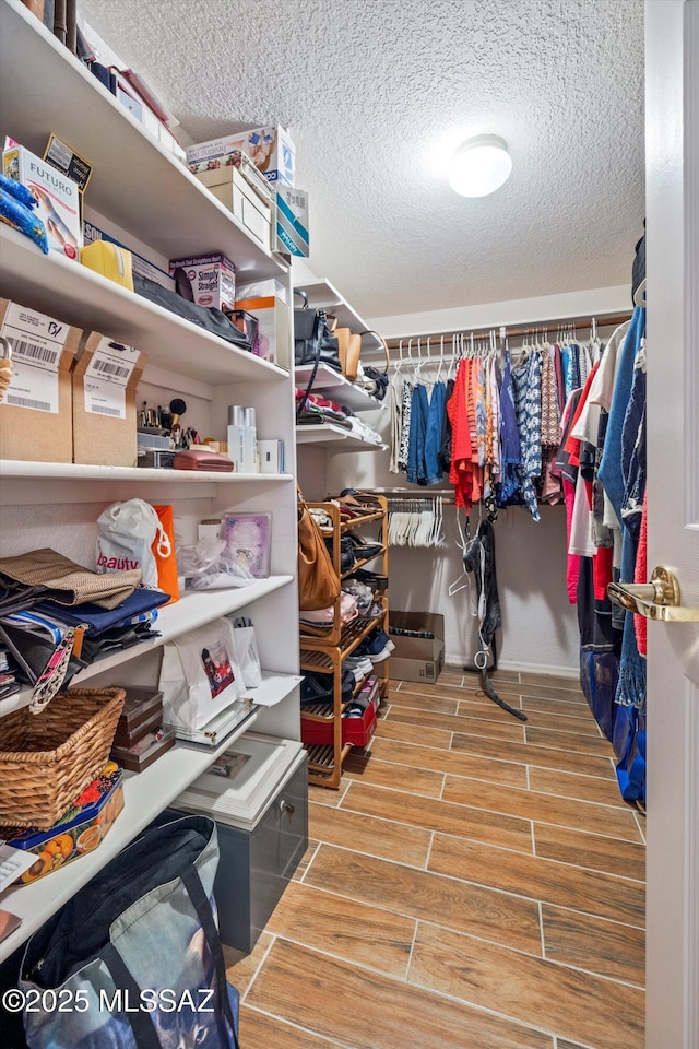 walk in closet featuring wood tiled floor