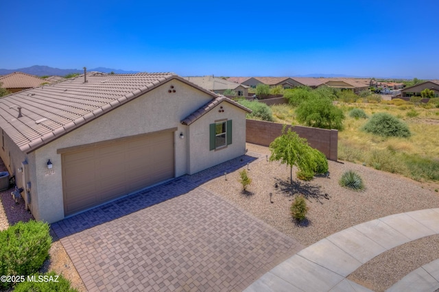 14172 E Vardo Dr, Vail, AZ 85641 - mediterranean / spanish home with stucco siding, a garage, decorative driveway, a tiled roof, and central AC