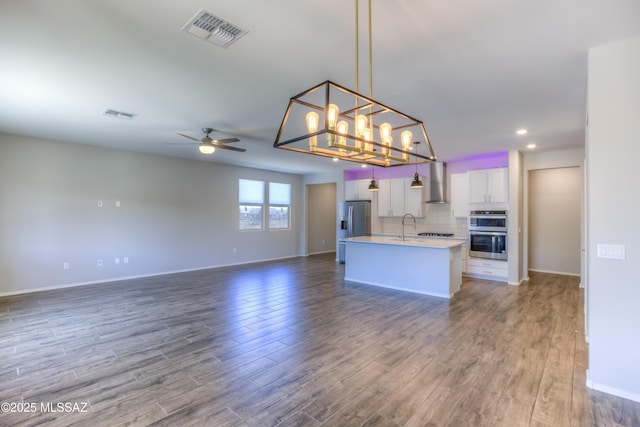 14172 E Vardo Dr, Vail, AZ 85641 - kitchen featuring open floor plan, wall chimney exhaust hood, wood finished floors, and recessed lighting