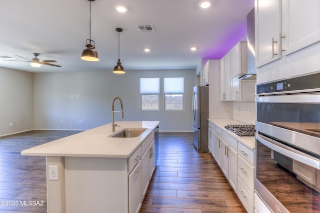 14172 E Vardo Dr, Vail, AZ 85641 - kitchen with a sink, appliances with stainless steel finishes, dark wood-type flooring, ceiling fan, and a kitchen island with sink