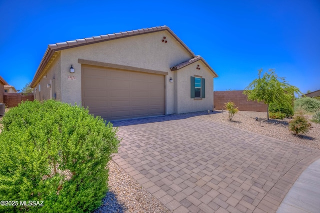 14172 E Vardo Dr, Vail, AZ 85641 - view of front of house with a garage, decorative driveway, central air condition unit, stucco siding, and a tile roof