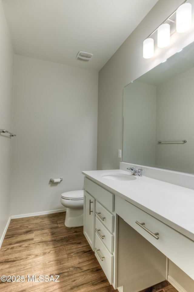 14172 E Vardo Dr, Vail, AZ 85641 - bathroom with vanity, wood finished floors, toilet, and baseboards