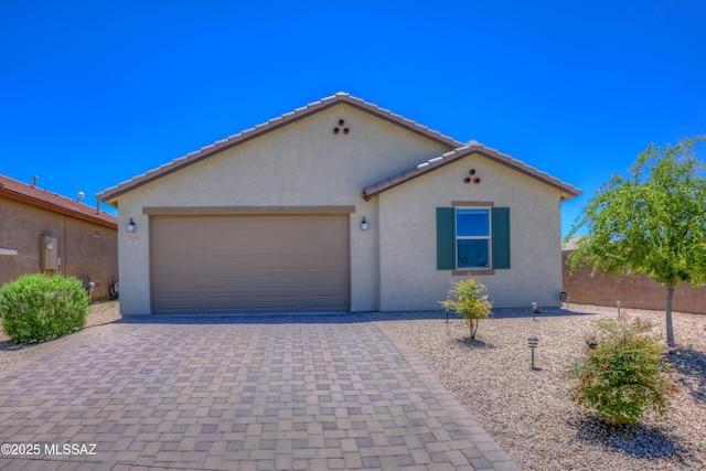 14172 E Vardo Dr, Vail, AZ 85641 - mediterranean / spanish-style house featuring stucco siding, a garage, decorative driveway, and a tiled roof