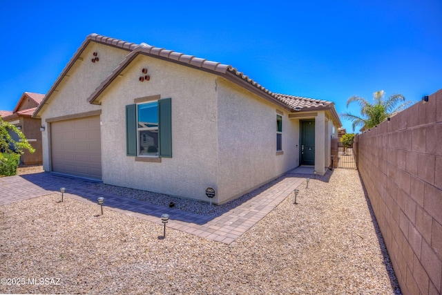 14172 E Vardo Dr, Vail, AZ 85641 - view of home's exterior with stucco siding, an attached garage, and a tiled roof