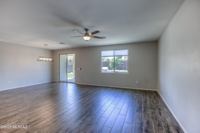 14172 E Vardo Dr, Vail, AZ 85641 - spare room featuring dark wood-style floors, ceiling fan, baseboards, and a chandelier