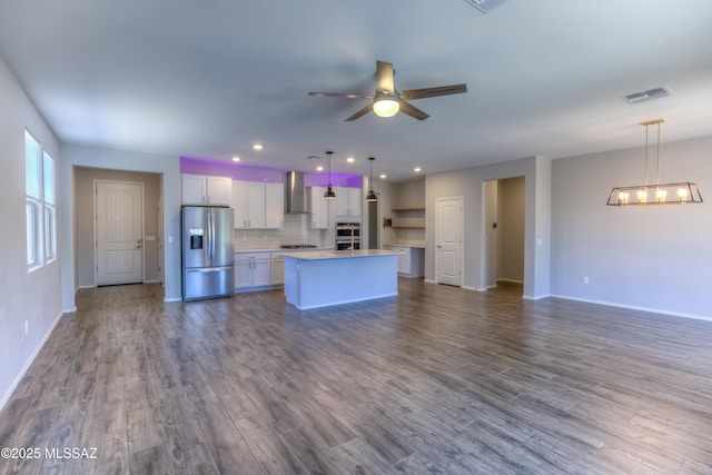 14172 E Vardo Dr, Vail, AZ 85641 - kitchen with appliances with stainless steel finishes, wall chimney exhaust hood, open floor plan, a chandelier, and recessed lighting