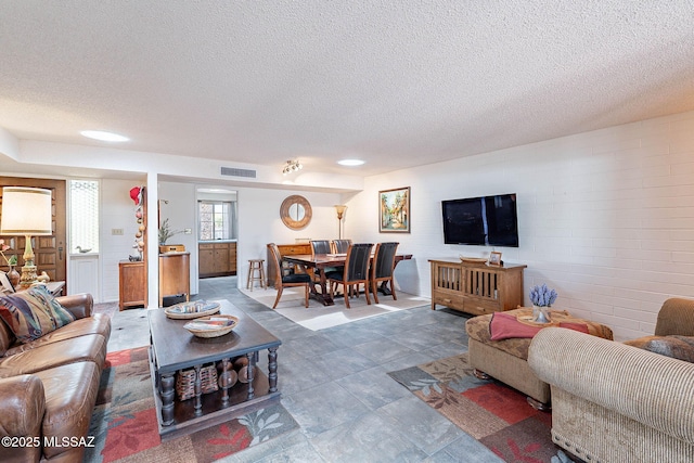 living room with visible vents and a textured ceiling