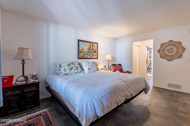 bedroom featuring visible vents and a textured ceiling