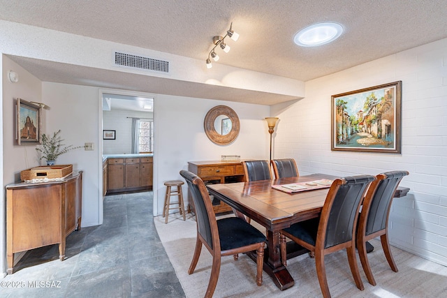 dining room with a textured ceiling and visible vents