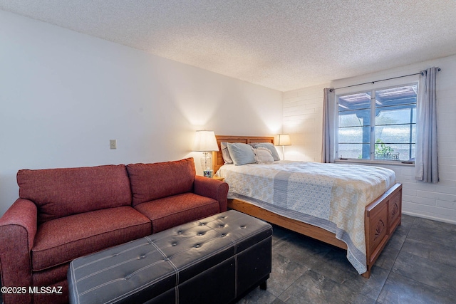 bedroom with stone finish flooring and a textured ceiling