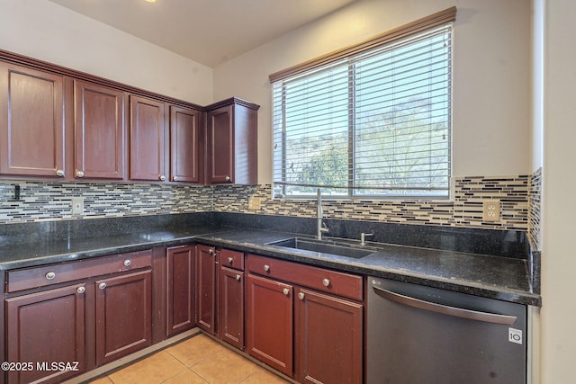 kitchen with stainless steel dishwasher, light tile patterned floors, decorative backsplash, and a sink