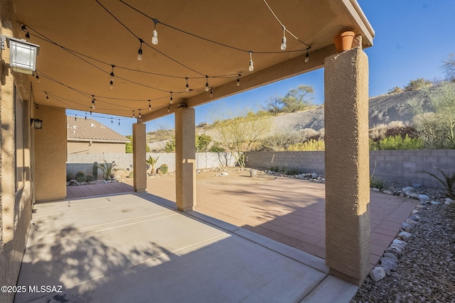 view of patio featuring a fenced backyard and a mountain view