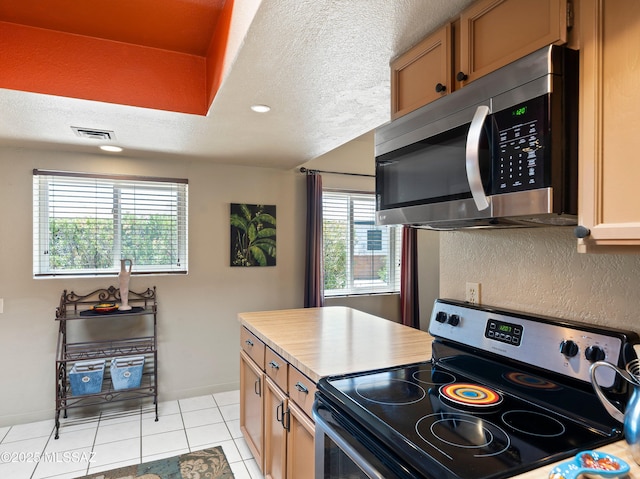 kitchen featuring visible vents, light tile patterned flooring, recessed lighting, a textured ceiling, and appliances with stainless steel finishes