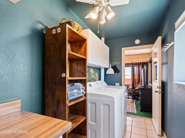 clothes washing area featuring cabinet space, ceiling fan, a textured wall, separate washer and dryer, and light tile patterned floors
