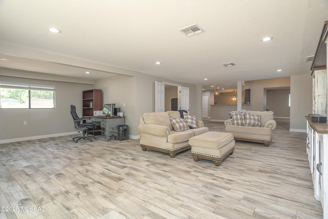 living area featuring visible vents, recessed lighting, baseboards, and light wood finished floors
