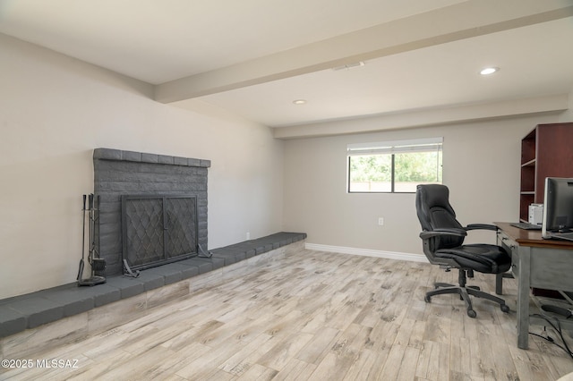 home office featuring recessed lighting, baseboards, wood finished floors, and a fireplace