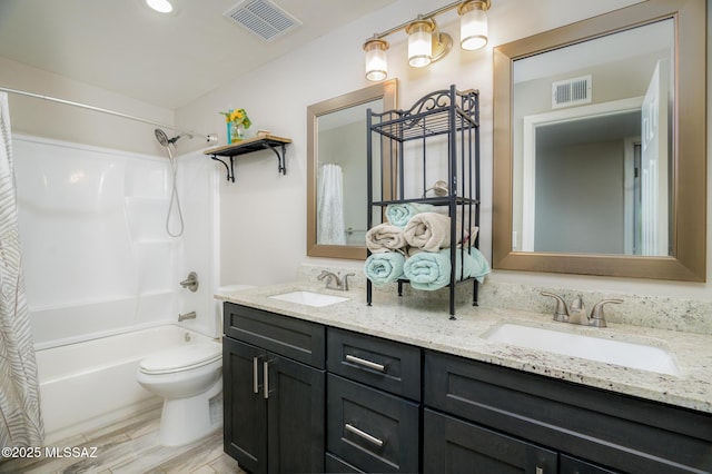 bathroom featuring visible vents, a sink, and shower / tub combo