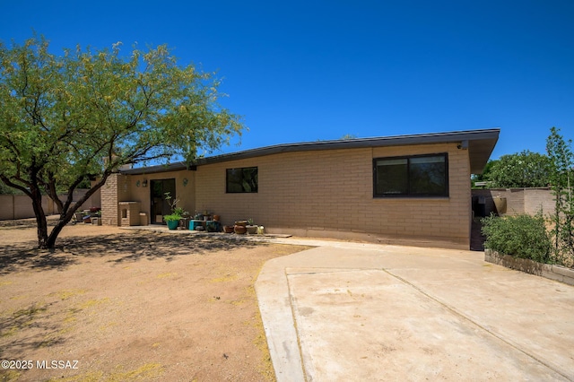 view of front of house featuring fence and a patio area