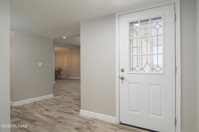 doorway to outside featuring baseboards, recessed lighting, and wood finished floors