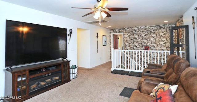 living area with visible vents, carpet flooring, and ceiling fan