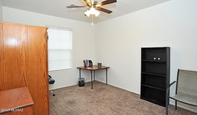 carpeted office space with baseboards, a ceiling fan, and a wealth of natural light