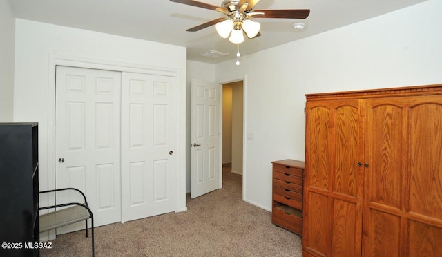 bedroom featuring a ceiling fan, light carpet, a closet, and visible vents