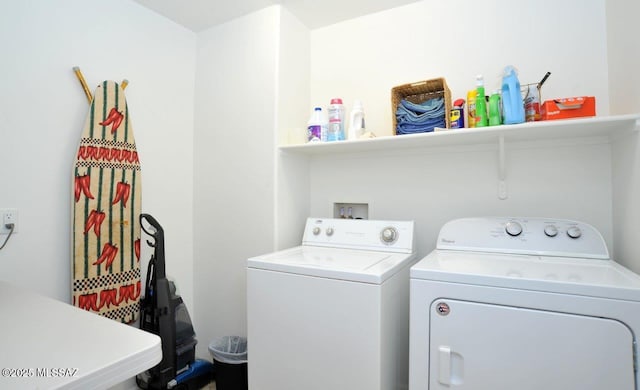 washroom with separate washer and dryer and laundry area