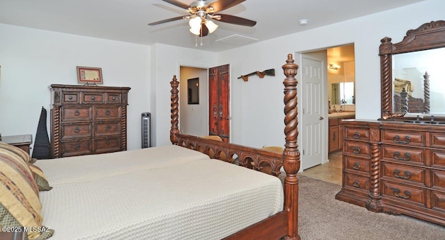 bedroom with light colored carpet, a ceiling fan, connected bathroom, and visible vents