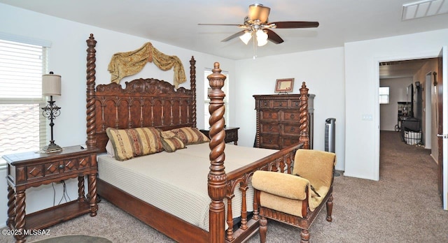 bedroom featuring multiple windows, carpet, and visible vents